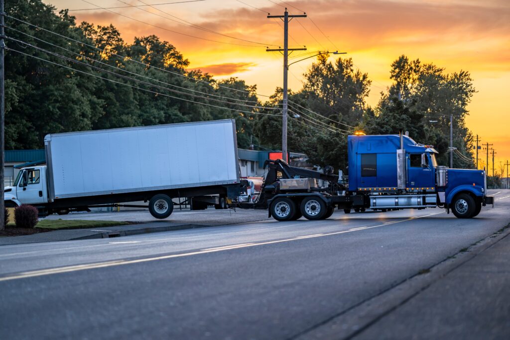 Box truck being towed away after accident